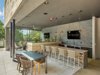 a bar with chairs and a table in front of a window